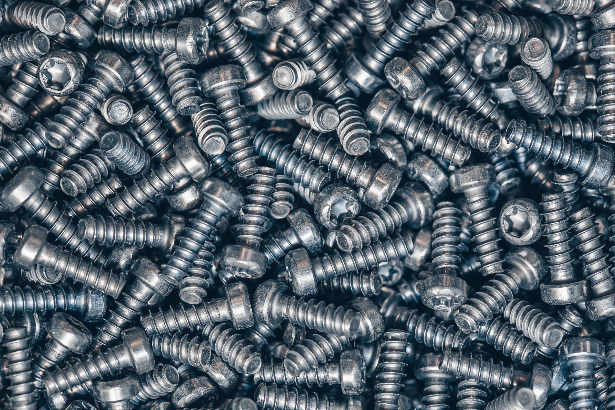 A lot of taping metal or iron screws, screws as a background, wallpaper or texture