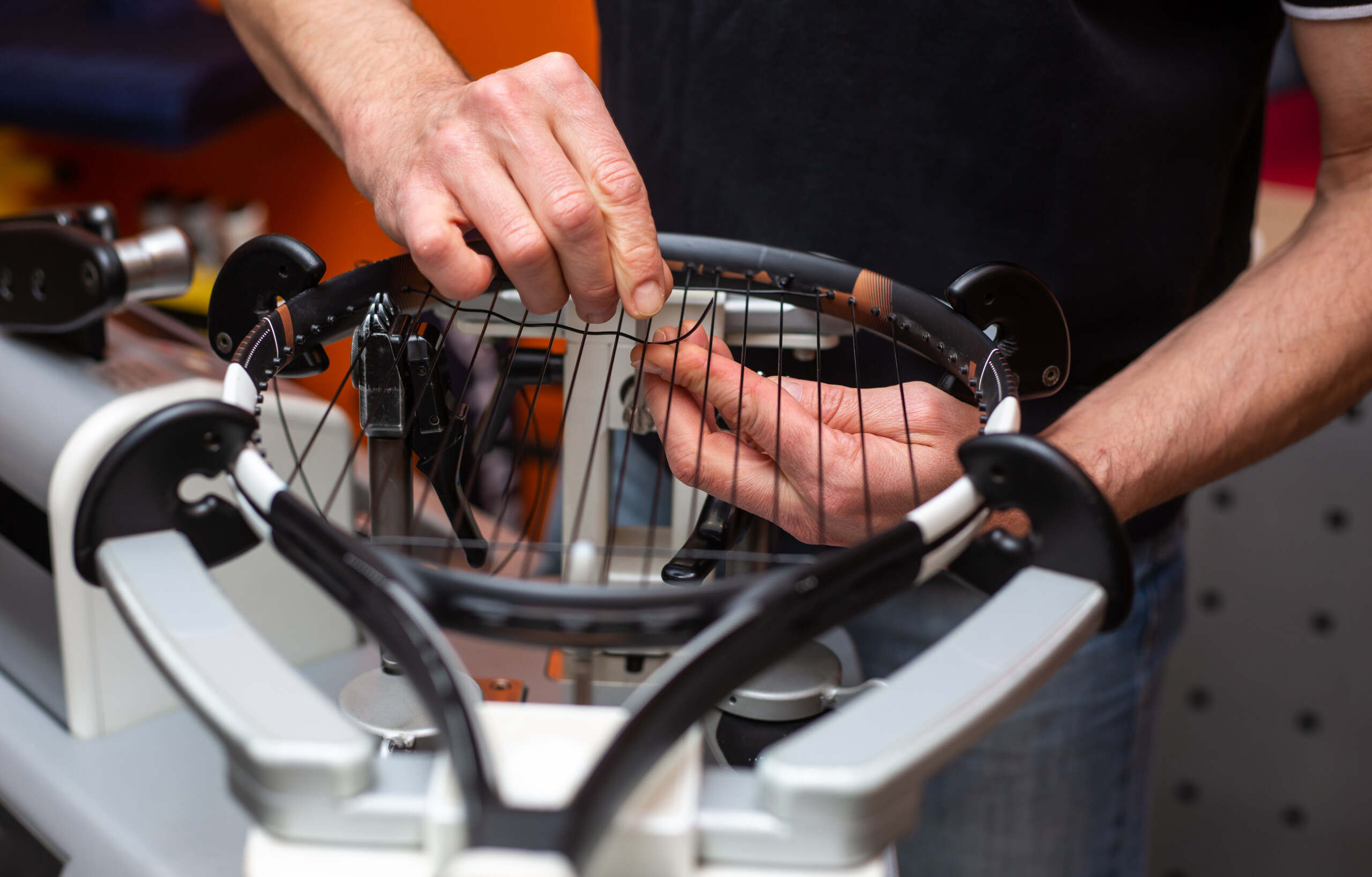 Process of stringing a tennis racket in tennis shop, sport and leisure concept